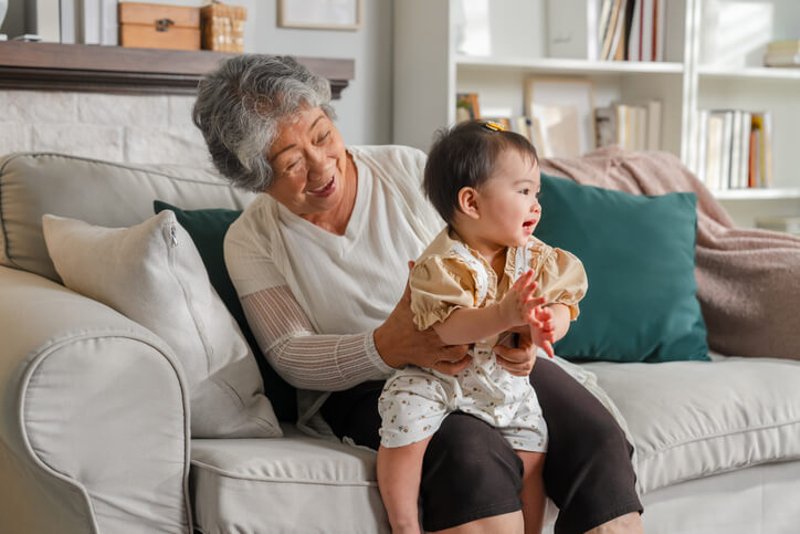 elderly grandparent holding grandchild