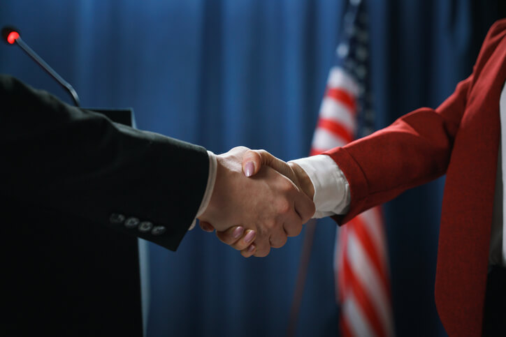 US flag handshake business agreement global